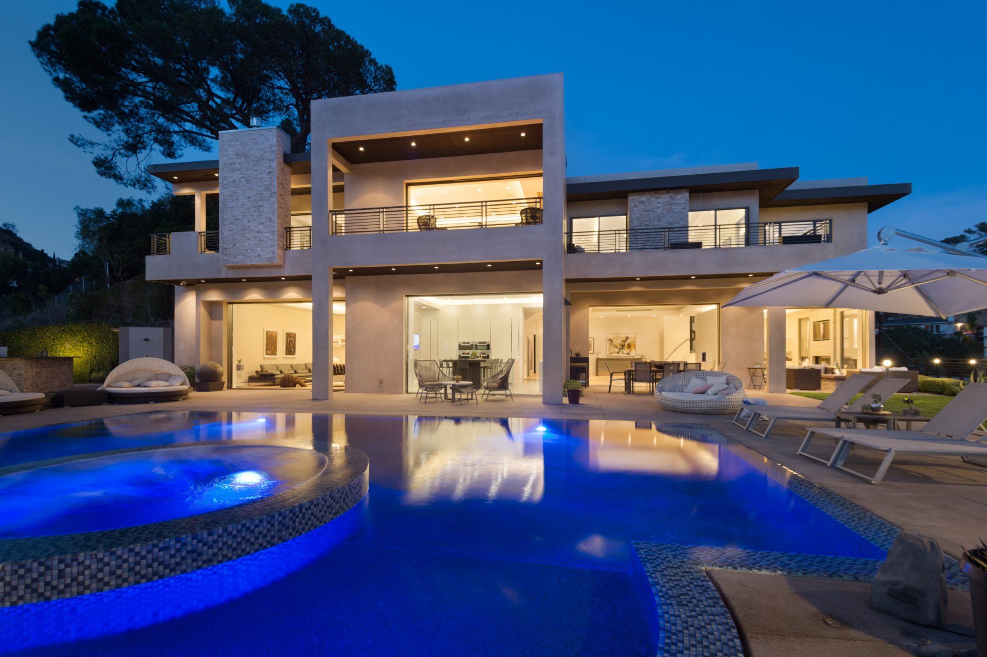 Modern hillside home by FEI with illuminated pool at dusk (2501 Zorada Dr, Hollywood Hills)